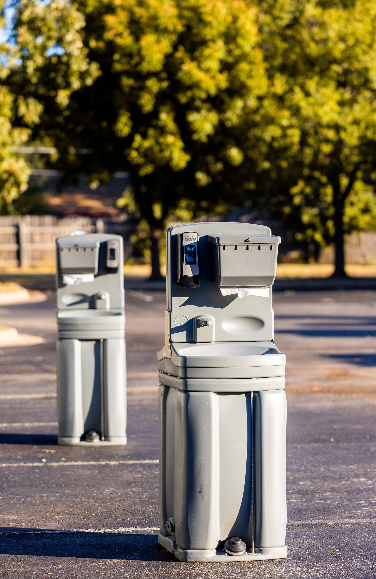 Two freestanding hand washing stations outdoors